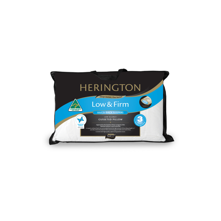 A Herington Low & Firm cushioned pillow in a black and white packaging sleeve with a blue and gold label, shown against a plain white background.