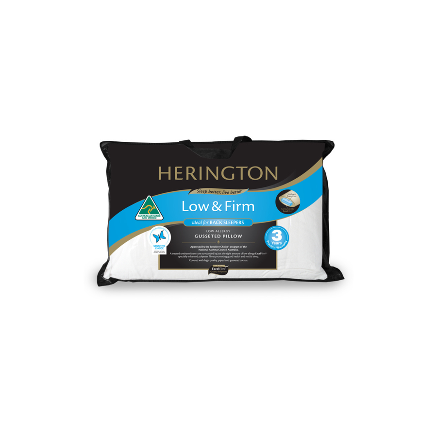 A Herington Low & Firm cushioned pillow in a black and white packaging sleeve with a blue and gold label, shown against a plain white background.